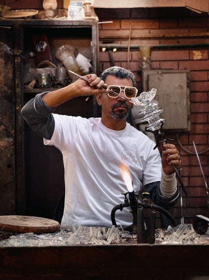 Handmade clear glass flower wall light in the making