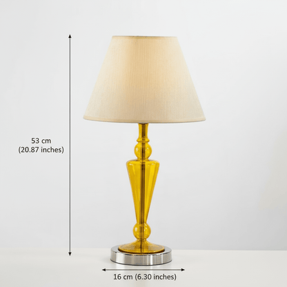 Table lamp with a yellow base and beige shade on a white background