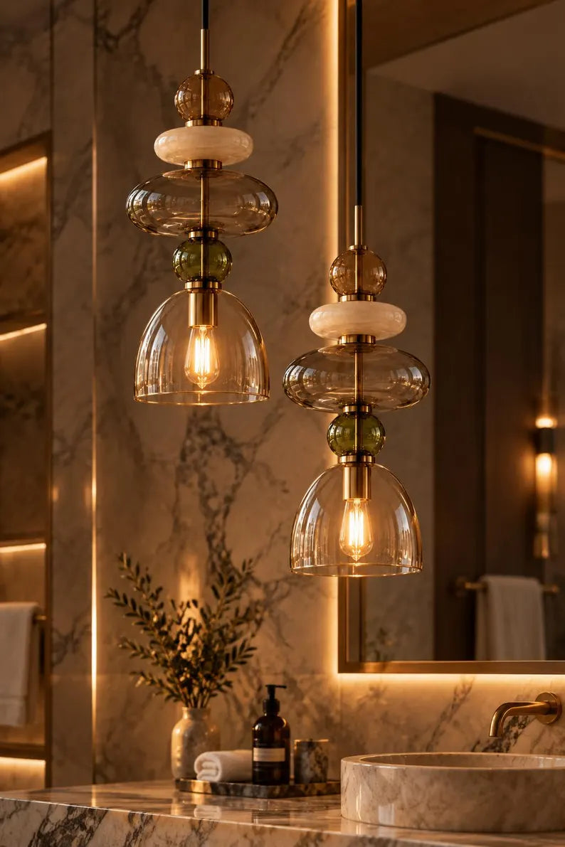 Handmade glass pendant light featuring amber, milky white, smoky grey and olive green glass elements, with brass accents and a clear champagne glass shade | Les Trois Pyramides