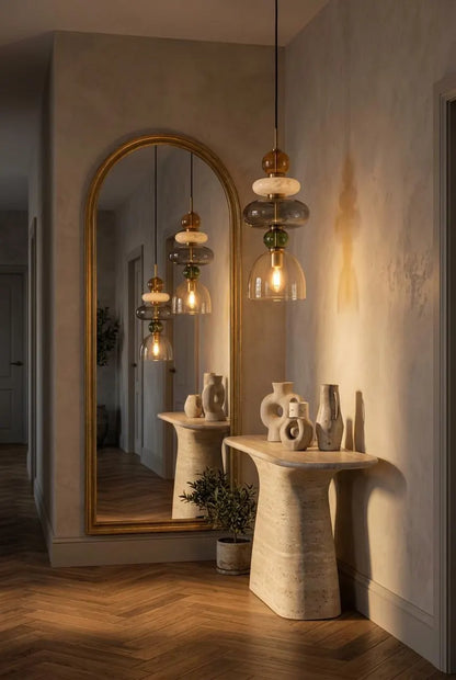 Handmade glass pendant light featuring amber, milky white, smoky grey and olive green glass elements, with brass accents and a clear champagne glass shade | Les Trois Pyramides