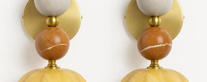 Two wall sconces with gold and marble design on a white background