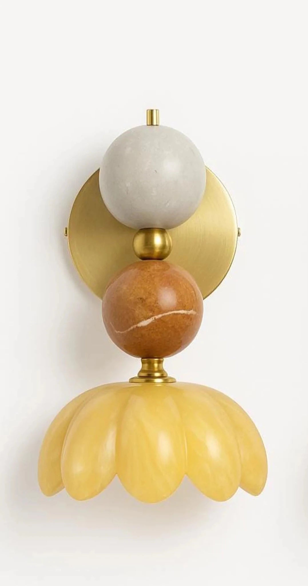 Decorative wall sconce with marble-like finish on a light background