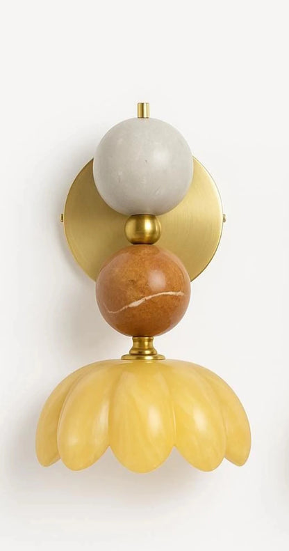 Decorative wall sconce with marble-like finish on a light background