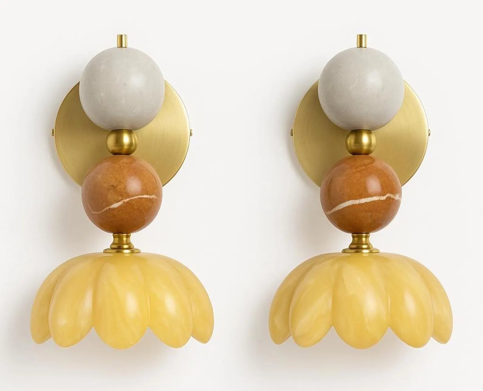 Pair of decorative wall sconces with marble and yellow design on a white background
