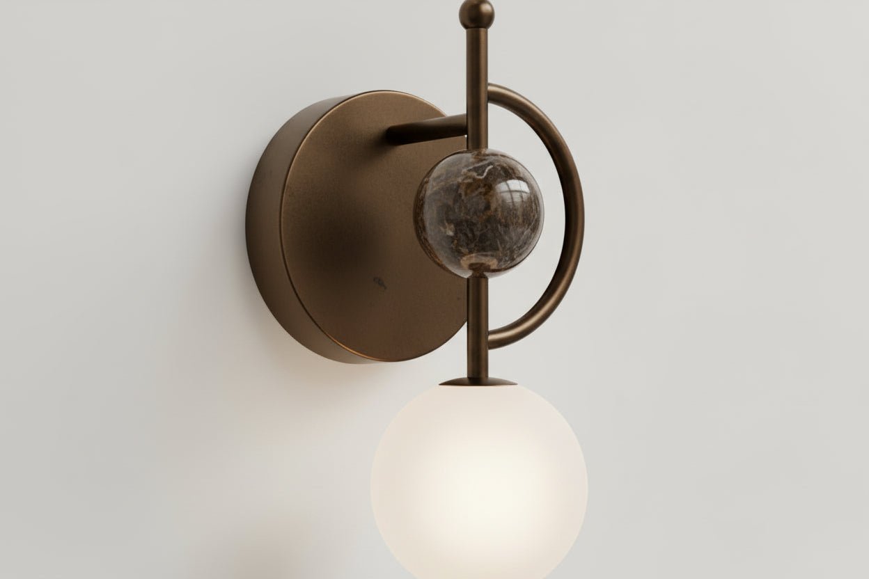 Handmade marble wall sconce with frosted glass globe and dark bronze metal finish
