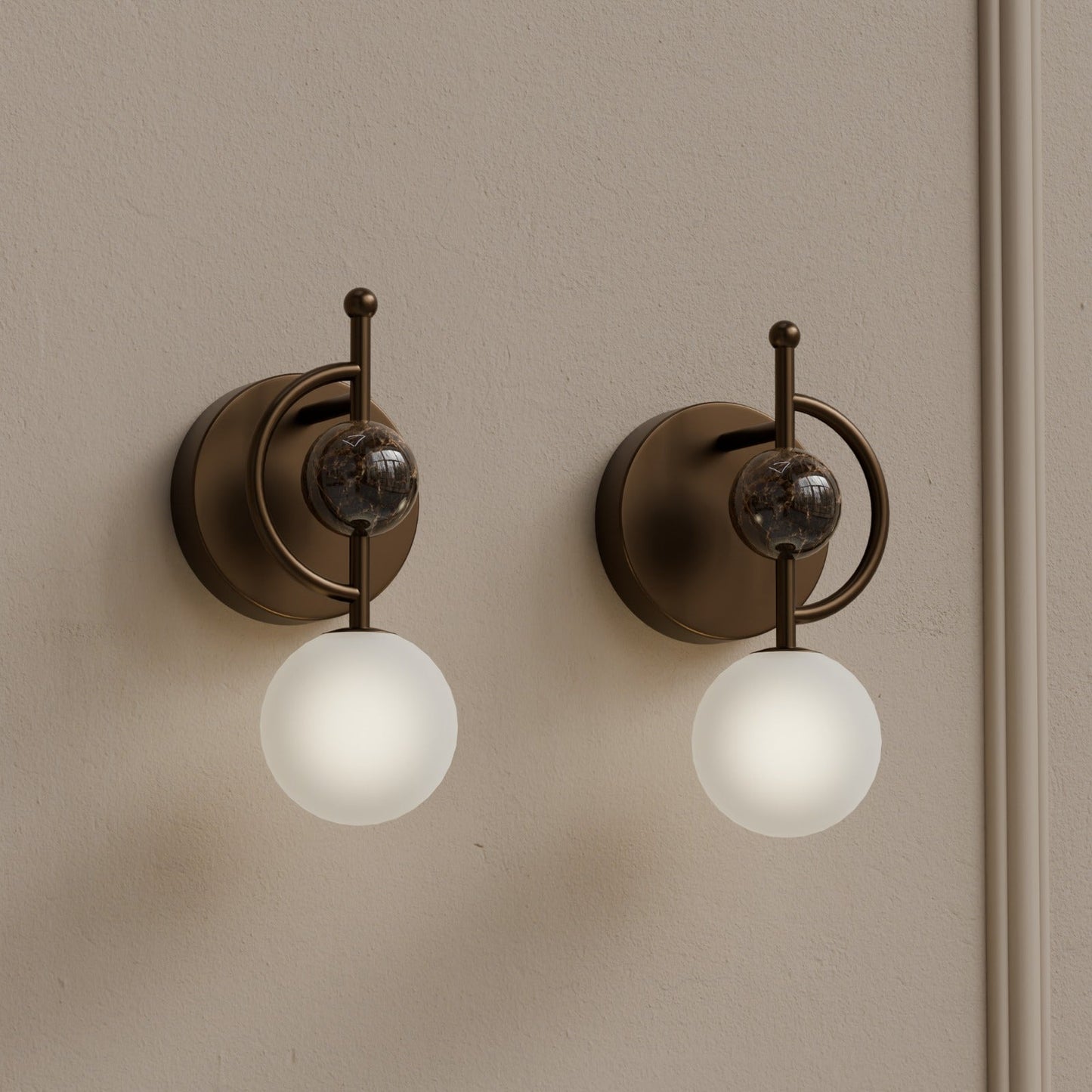 Pair of marble wall sconces with frosted glass globes installed on interior wall
