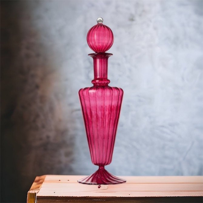 Miniature Red blown glass decanter on wooden table | Les Trois Pyramides