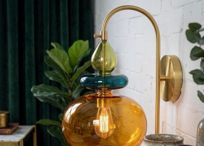 Wall-mounted lamp with colorful glass shades in a home setting