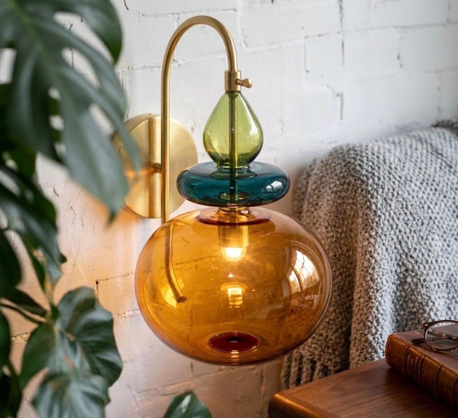 Decorative wall lamp with colorful glass shades in a home setting.