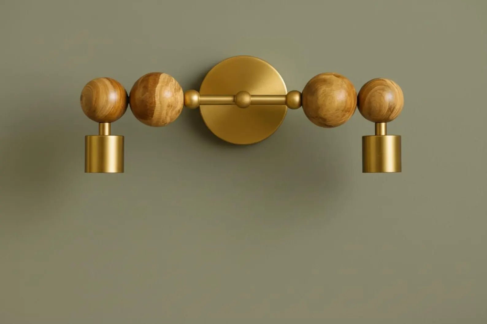 Decorative wall light fixture with wooden and gold elements on a green background