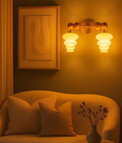 Cozy living room corner with a sofa, wall sconces, and decorative elements.