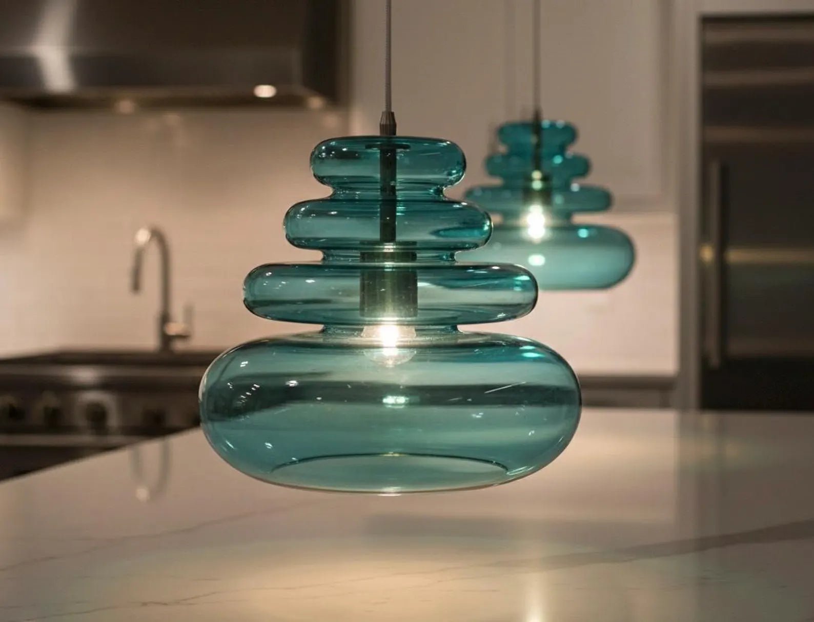 Teal glass pendant light in a kitchen setting