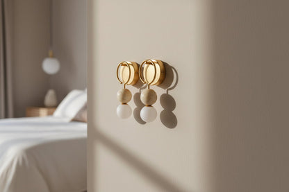Modern marble and brass wall sconce with frosted glass used in bedroom interior