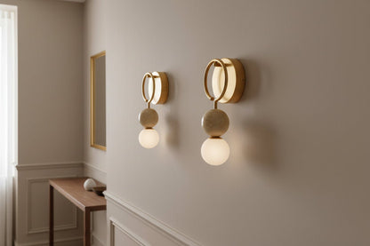 Modern marble and brass wall sconce with frosted glass used in Living room interior