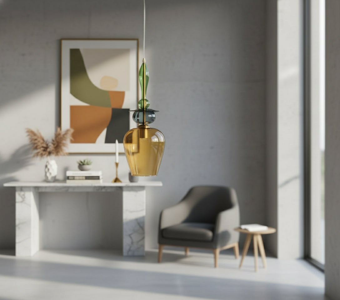Modern pendant light with green and amber glass shades in a minimalistic room.
