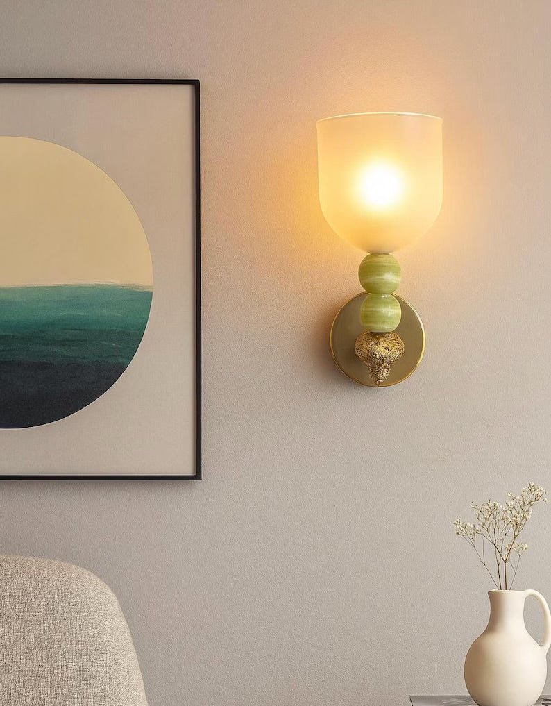 Set of two onyx stone wall sconces installed on interior wall with warm ambient lighting
