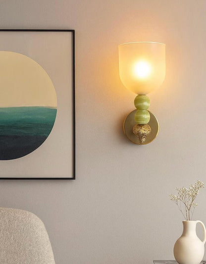 Set of two onyx stone wall sconces installed on interior wall with warm ambient lighting
