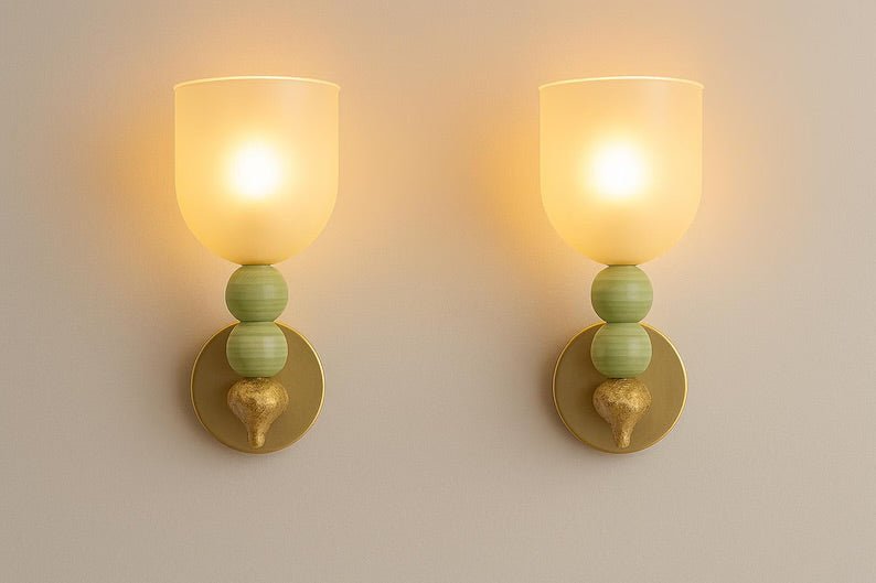 Handmade onyx stone wall sconces glowing with warm diffused light through frosted glass
