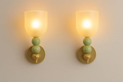 Handmade onyx stone wall sconces glowing with warm diffused light through frosted glass
