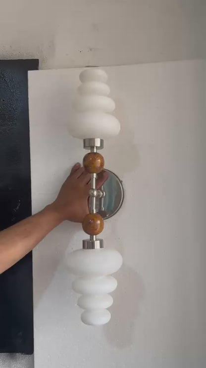 Double brass wall sconce with frosted glass shades and onyx stone details