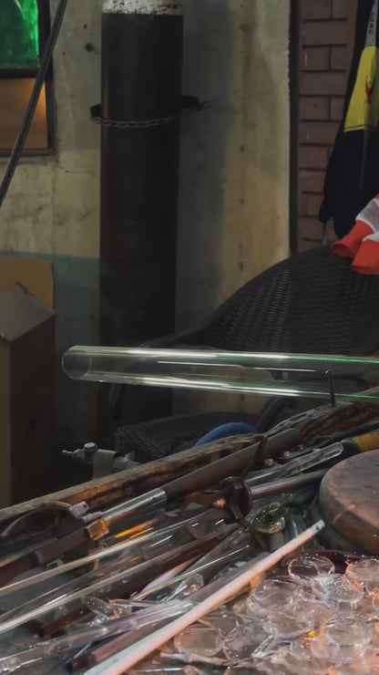 Glassblower shaping clear glass flower shade for upside down bloom wall sconce