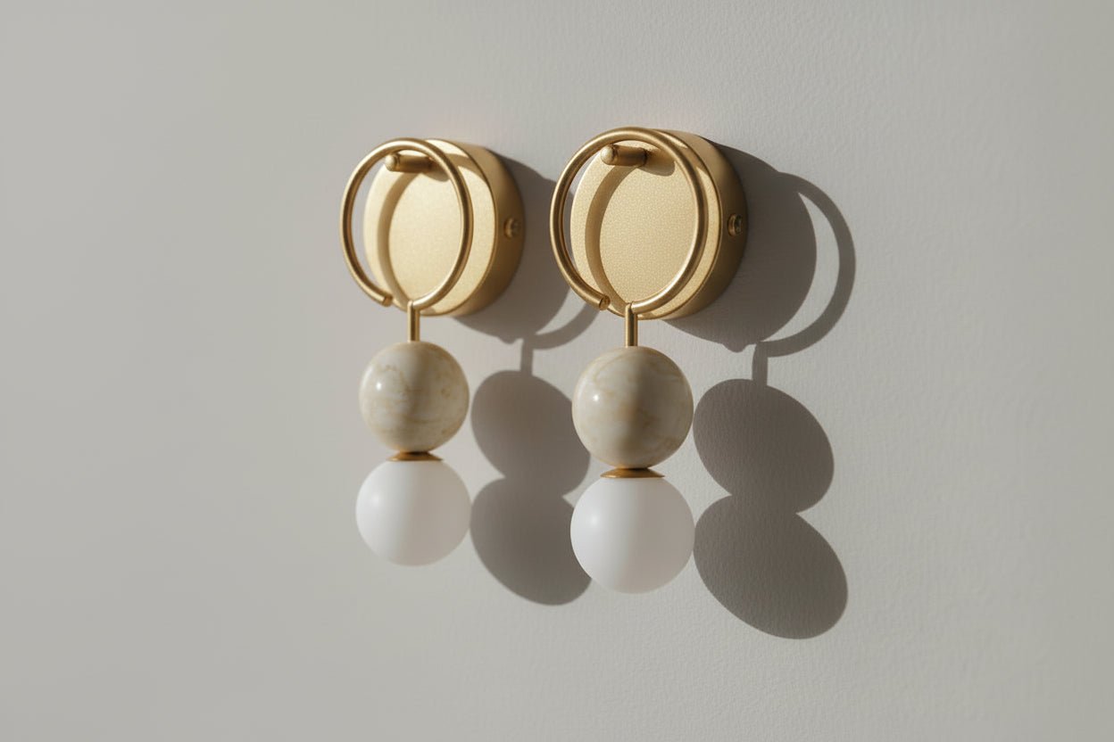 Round brass wall light with solid marble spheres and frosted glass globe