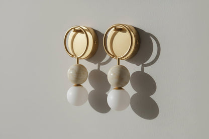 Round brass wall light with solid marble spheres and frosted glass globe