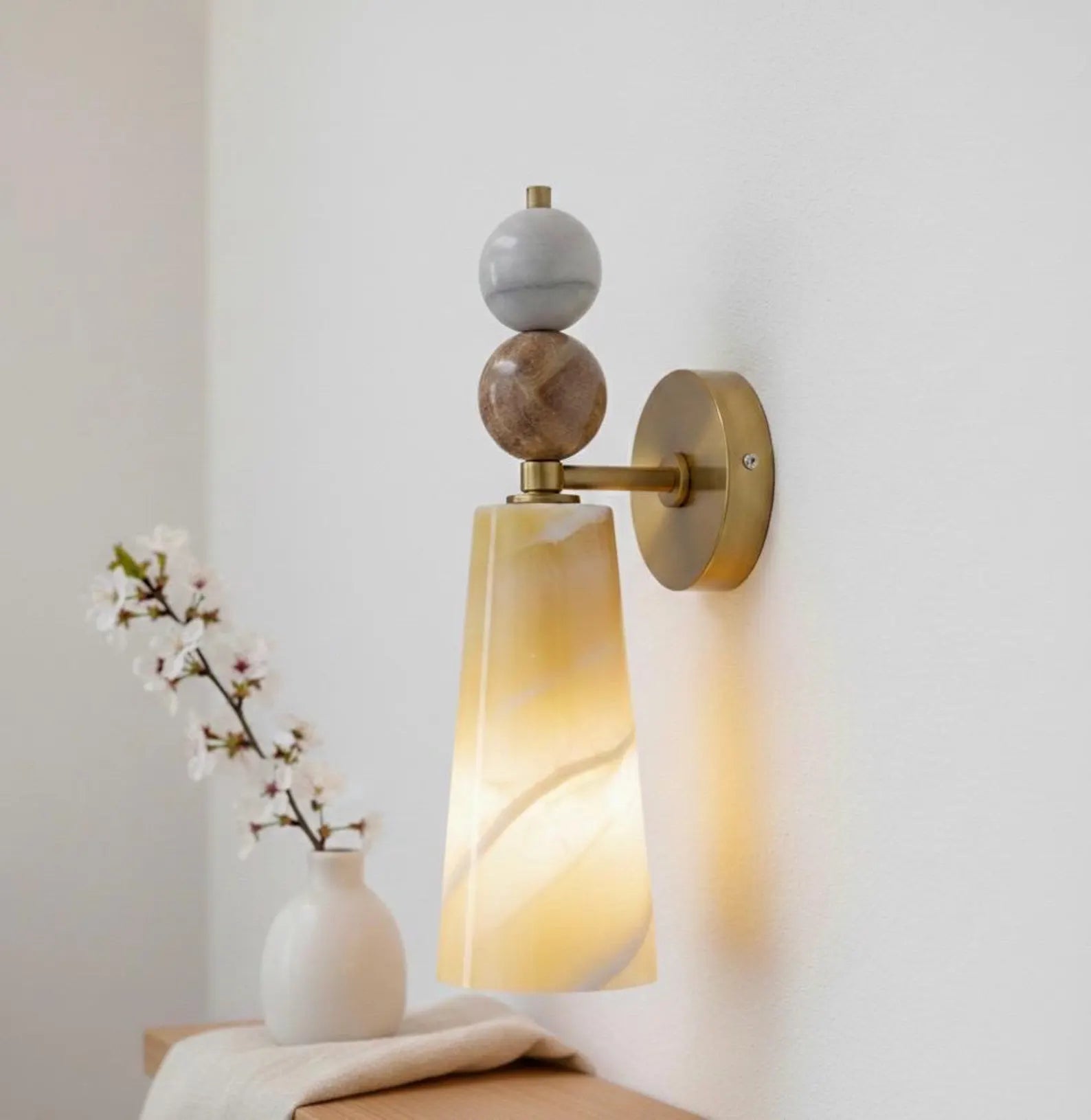 Decorative wall sconce with marble-like finish