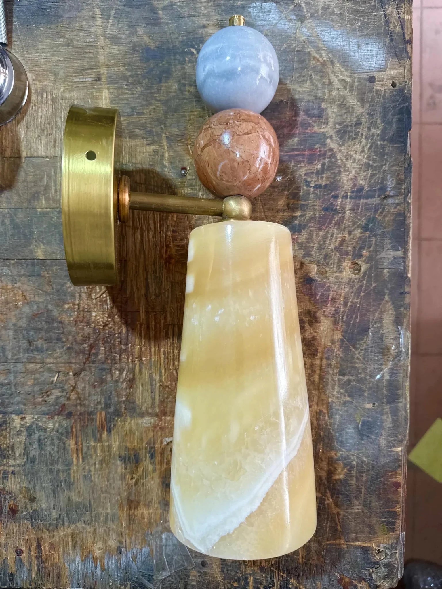 Decorative wall sconce with beige stone, pink stone, and blue stone 