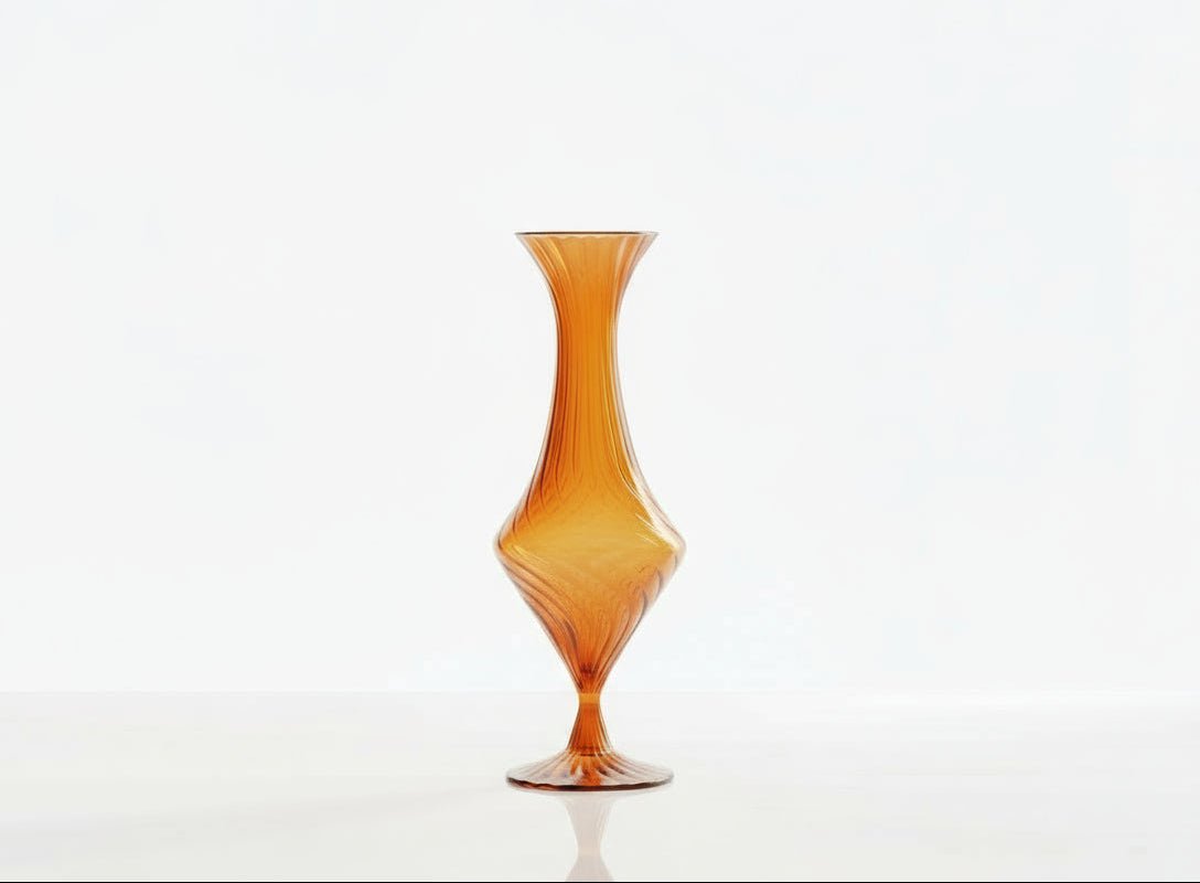 Two glass vases, one orange and one green, with decorative plants on a white background.