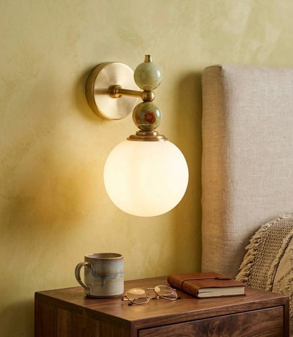 Wall-mounted lamp with a warm glow on a bedside table 