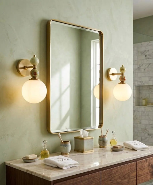 Bathroom vanity with mirror, lights, and various items on a light green wall.