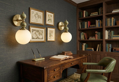 Hand adjusting a wall-mounted light fixture with marble accents on a plain wall.