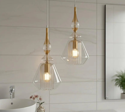 Two pendant lights with gold accents hanging in a bathroom.
