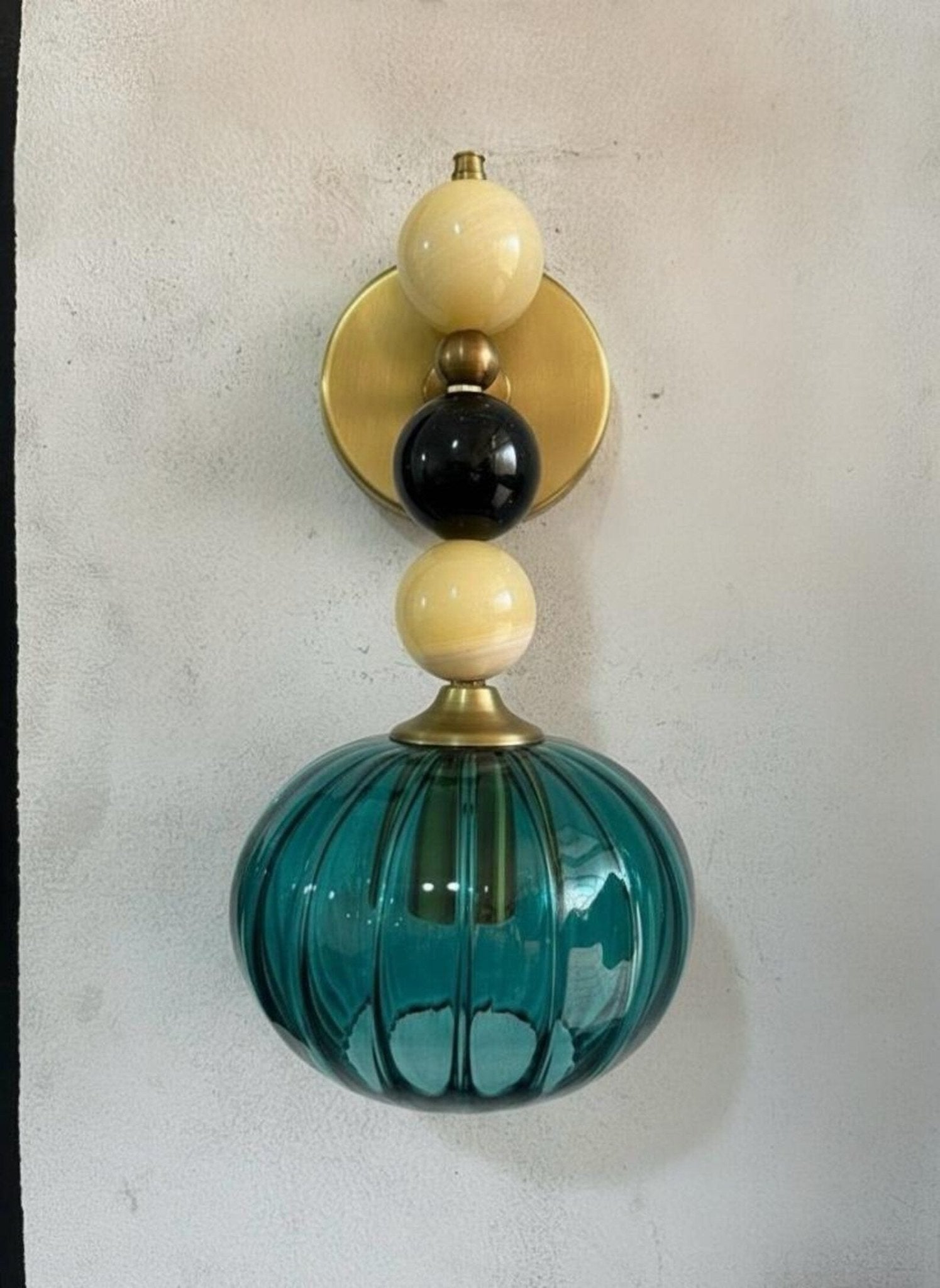 Handmade Ribbed Turquoise Glass Wall Sconce with Natural Marble Stones – Brass Mount Light | Les Trois Pyramides. 