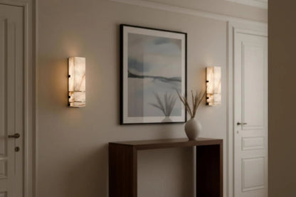 Modern interior design with wall sconces, a console table, and a framed artwork.