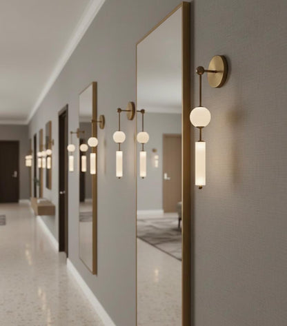 Modern hallway with wall-mounted lights and mirrors reflecting the interior.