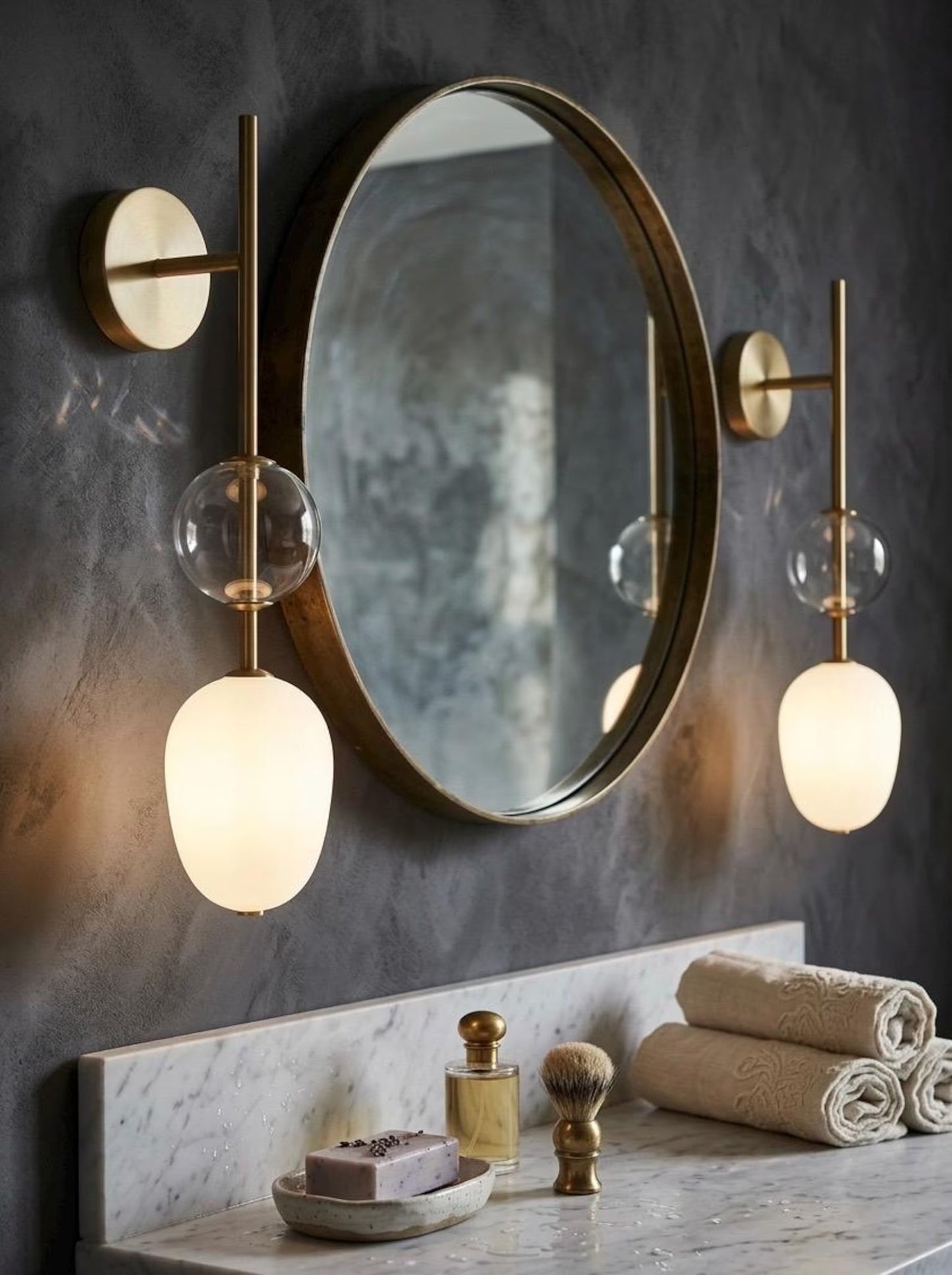 Bathroom vanity with round mirror and wall lights against a dark wall.